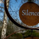 A metal sculpture, with the word silence.