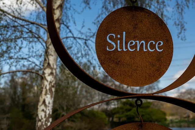 A metal sculpture, with the word silence.